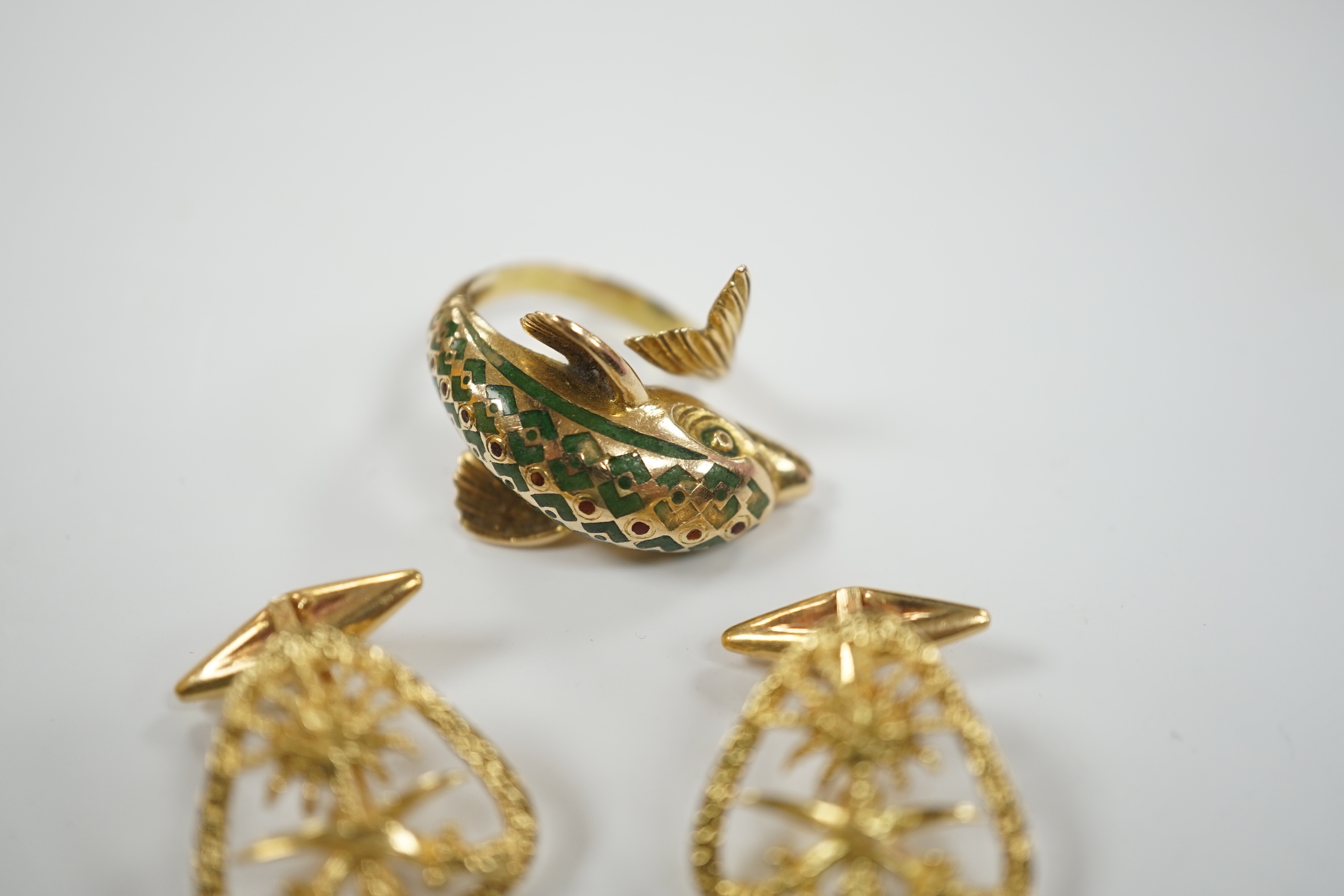 A continental 18k and two colour enamel dolphin ring, size N and a pair of 750 yellow metal Middle Eastern cufflinks